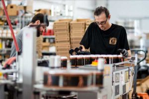 Employee quality controlling beer canning line at Copperpoint Brewery in Boynton Beach, FL.